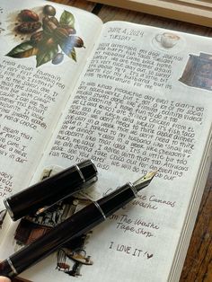 two fountain pens sitting on top of an open book with writing in the pages next to it