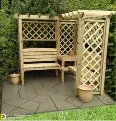 a wooden bench sitting in the middle of a garden