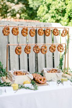 donuts hanging from a rack on a table