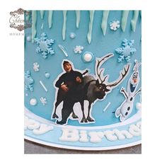 a birthday cake decorated with an image of a man and reindeer