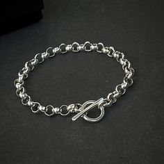 Classic sterling silver rolo chain bracelet,  minimal yet bold.  Details: Chain: Sterling Silver Rolo Chain, 6.3mm Clasp: Sterling Silver Toggle Clasp Sizes: 5" to 10"  Full and half sizes Shipping: Ships within one business day Free shipping in the USA, USPS Ground Advantage  Upgrade to Priority or Express available in check-out To determine bracelet size, follow the steps below: 1. Measure your wrist below the wrist bone (where you would normally wear your bracelet) using a flexible measuring tape or a strip of paper. 2. If using a plain strip of paper, mark your strip with a pen where the end of the bracelet needs to be. Then measure the paper strip with a ruler. This is the wrist size. 3. To find the bracelet size, increase the wrist measurement by the increment below, based on how you Everyday Sterling Silver Bracelet With Toggle Clasp, Silver Minimalist Bracelet With Chunky Chain, Minimalist Silver Bracelets With Chunky Chain, Minimalist Link Bracelet With Rolo Chain, Minimalist Link Bracelets With Rolo Chain, Minimalist Rolo Chain Link Bracelet, Modern Sterling Silver Rolo Link Bracelet, Modern Everyday Rolo Chain Bracelet, Sterling Silver Rolo Chain Bracelet For Everyday