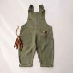 Kids linen gender neutral dungarees with adjustable straps and front pockets. This item is MADE TO ORDER. Please allow up to 3-7 business days production time before shipping.  Material: 100% medium weight linen, Oeko-Tex 100 certified. Size Chart (this item runs true to the size): Newborn (52 cm / 20.5 in. height) 0-3 months (62cm / 24in. height) 3-6 months (68cm / 27in. height) 6-12 months (80cm / 31.5in. height) 12-18 months (84cm / 33in. height) 18-24 months (90cm / 35in. height)  2-3 YRS (96cm / 38in. height) 3-4 YRS (104 cm / 41in. height) 4-5 YRS (110cm / 43in. height) 5-6 YRS (116cm / 45.5in. height) Recommended Care Instructions: Machine wash cold water, delicate cycle, dry gentle. Summer Bib Front Shortalls With Pockets, Summer Bib Front Solid Overalls, Cotton Overalls With Adjustable Straps, Utility Bib Front Overalls With Suspenders, Summer Overalls With Bib Front, Solid Color Summer Overalls With Bib Front, Utility Style Overalls With Bib Front And Suspenders, Utility Style Overalls With Suspenders And Bib Front, Utility Overalls With Suspenders And Bib Front