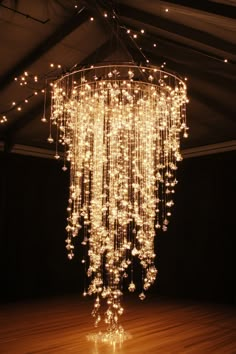 Wedding ceiling display. Waterfall crystal chandelier with cool white fairy lights.  Ignite your imagination and illuminate your most magical day with our compilation of 36 Enchanting Wedding Light Installation Ideas. Who knew that the right lighting could add an extra layer of whimsical charm and turn an ordinary venue into a mesmerizing wonderland? Dive into this enlightening treasure of ideas, perfect…  Read more: https://tastywed.com/generated-post-36-enchanted-wedding-light-installation-ideas/ Twinkle Light Canopy Wedding, Balloon Chandelier Wedding, Lantern Wedding Theme, Wedding Lights Decorations, Diy Chandelier Wedding, Fairy Lights Wedding Decor, Diy Wedding Chandelier, Magical Chandelier, Wedding Venue Lights