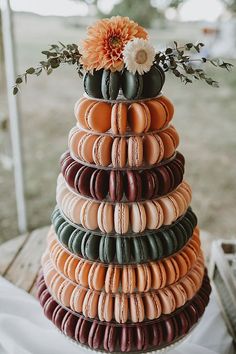 a stack of macaroons on top of each other with a flower in the middle