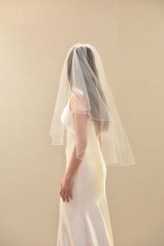 a woman in a white dress wearing a veil