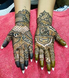 two hands with henna tattoos on them