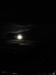 the full moon is shining brightly in the dark sky