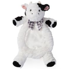 a white stuffed animal with black spots and a bow on it's neck, standing upright