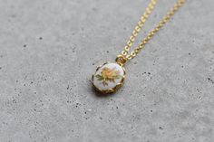 This vintage floral pendant dates back to the 1960's! The pendant hangs on a delicate 16K gold plated chain. The pendant measure 8x10mm. If you would like a chain length not offered, simply write it in the notes at the time of purchase. All parts are nickel and lead free.  Every piece comes gift wrapped in a canvas bag. If you would like to include a message, write it in the notes and we will make a little card with the order. Like us on Facebook and Instagram for updates on new products, special discounts and VA happnins!  https://www.facebook.com/TheVintageAcorn https://instagram.com/vintageacorn/ Vintage Rose Design Necklace For Gift, Vintage Jewelry With Rose Design Flower Pendant, Vintage Rose Design Pendant Jewelry, Vintage Rose Design Flower Pendant Jewelry, Vintage Rose Design Flower Pendant Necklace, Vintage Gold Jewelry With Flower Charm, Vintage Jewelry With Delicate Chain For Everyday, Vintage Birth Flower Necklace For Wedding, Vintage Necklaces With Flower Charm Round Pendant