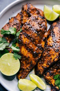 grilled chicken with limes and cilantro on a plate