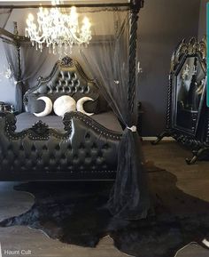 a bed with black leather headboard and canopy