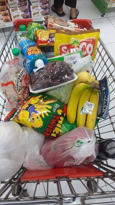 a shopping cart filled with lots of different types of food and snacks in it's basket