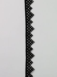 a black ribbon with white dots on it