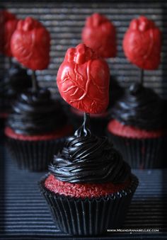 chocolate cupcakes with red frosting and hearts on top