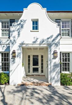 a white house with black shutters and windows