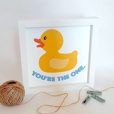 a ball of twine next to a rubber ducky with the words you're the one on it