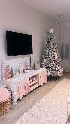 a living room with a christmas tree and tv