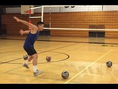 a young man is kicking some balls on the floor in an indoor gym with hard wood floors