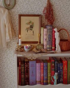 a shelf filled with lots of books next to a wall mounted clock and other items