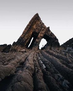 the rock formations are made up of large pieces of wood and rocks, with an opening in the middle