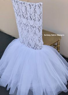 a white tulle skirt sitting on top of a chair