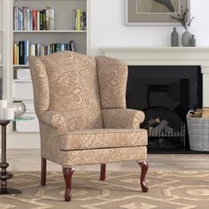 a living room filled with furniture and a fire place next to a book shelf full of books