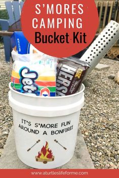 a bucket filled with snacks and camping items