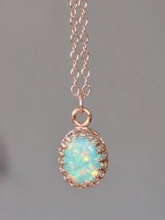 "A lovely necklace made using 14K rose gold filled components and a white opal. The opal is oval in shape and has flashes of pinks, greens, blues and so much more with every turn of the stone! It is my favorite color opal and is a lovely shade of mint green. It's been hand-set into a premium 14K rose gold plated brass crown setting. The pendant hangs from 14k rose gold filled chain. Necklace closes with a gold filled clasp. Opal measures 10mm long (just shy of 1/2\"). Please choose desired chain Delicate Rose Gold Gemstone Necklaces, Delicate Rose Gold Gemstone Necklace, Delicate Rose Gold Oval Pendant Jewelry, 14k Rose Gold Necklace, 14k Rose Gold Jewelry For Gift, Rose Gold Gemstone Oval Pendant Jewelry, Rose Gold Oval Pendant Jewelry With Gemstone, 14k Rose Gold Necklaces For Jewelry Making, 14k Rose Gold Pendant Jewelry