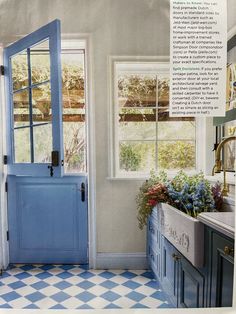 a blue front door in a kitchen with checkered flooring and white walls on both sides