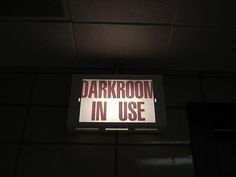 a sign that reads darkroom in use