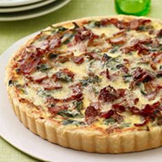 a quiche with bacon and cheese on a plate