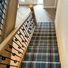 the stairs are decorated with black and blue carpeted stair treads that lead up to the second floor