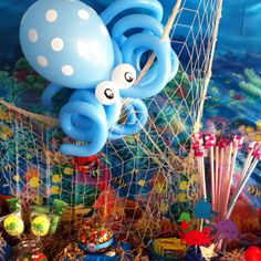 an octopus themed birthday party with balloons and streamers in the shape of fish net