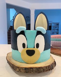 a cake shaped like a dog on top of a tree stump in the shape of a head