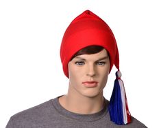 Simple red phrygian style cap.  This  hat has a handtied red white and blue tassel made of yarn. A traditional liberty cap, symbolizing freedom and liberty going back into ancient history. Phrygian hat's have an ancient history of being the symbol of liberty and freedom.   The phrygian hat is used in the seal of several states and is in the seal of the US senate. Start a revolution. This hat is made from fleece.  Machine washable. Long red, white and blue tassel on point. Made from soft fleece. Hat Base, Us Senate, Blue Tassel, Fabric Bolts, Long Red, Costume Hats, Mascot Costumes, Cotton Velvet, Knit Cotton