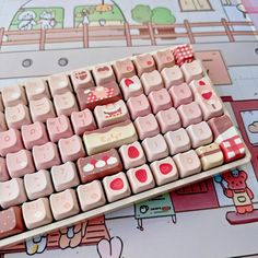 a pink and white keyboard with hearts on it