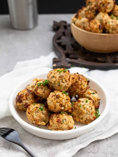 a white bowl filled with meatballs on top of a table