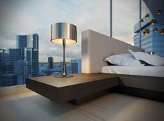 a bed with white sheets and pillows in a room next to a window overlooking the city