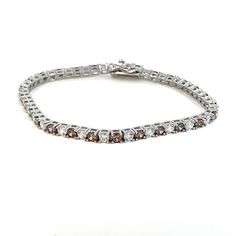 Introducing our stunning Rhodium-Plated Italian-Made Tennis Bracelet, a harmonious fusion of Italian craftsmanship and timeless elegance. Crafted with meticulous attention to detail in Italy, this bracelet is adorned with exquisite white and cognac-coloured stones set in .925 Italian Silver, creating a mesmerizing symphony of colour and brilliance. Each stone is carefully selected for its impeccable clarity and captivating hue, expertly set within the shimmering links of the bracelet. The altern Timeless White Sterling Silver Bracelet With Diamond Accents, White Sterling Silver Bracelet With Diamond Accents For Wedding, Elegant White Bracelets With Diamond Accents, Formal White Bracelets With Elegant Design, White Diamond Bracelets With Sparkling Stones, White Diamond Bracelet With Sparkling Stones In Sterling Silver, White Jubilee Bracelet Jewelry With Cubic Zirconia, White Elegant Bracelets For Formal Occasions, White Cubic Zirconia Jubilee Bracelet