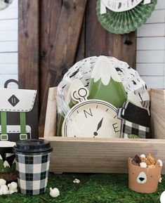 a table topped with plates and cups filled with food next to a wooden sign that says happy new year