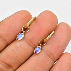 Rainbow Moonstone charms for earrings (Pair) ✪Gemstone: Natural Rainbow Moonstone ✪Metal: 18k solid yellow gold. ✪Stone size: 6x4 mm. ✪Stone Shape : Pear ✪Stone Weight : 0.80 Ct. ✪ Charm Weight : 0.480 Gram ✪Charm + Hoop Weight : 1.480 Gram Approx. ✪Charm Length : 12 mm. ✪Charm width : 5 mm. ✪Bail size inside : 3.5 mm. ✪Fit Up To 3 mm Wide Hoops. ✪Hoop Size inside : 8 mm. ✪Hoop Width : 1.5 mm ✪Setting type: Bezel wire setting. If you need any other preferred stone please contact us. Rainbow Moonstone benefits - *Moonstones have a highly spiritual nature, and you may benefit by putting this vibration to work in your life.  *It is a stone that enhances your feelings and encourages fervent desires, eager expectation and heartfelt resolve.  *It holds within it the deep seated nature of feminin Gemstone Dangle Huggie Earrings Gift, Hypoallergenic Gold Moonstone Jewelry, Dainty Dangle Hoop Earrings With Gemstones, Round Moonstone Hoop Earrings As A Gift, Gold Moonstone Dangle Hoop Earrings, Moonstone Hoop Earrings Gift, Dainty Gemstone Huggie Earrings For Gift, Dainty Gemstone Huggie Earrings As Gifts, Handmade Teardrop Huggie Earrings For Gift