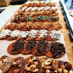 a table topped with lots of different kinds of cookies and pretzels on top of each other