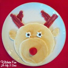 a white plate topped with a cake shaped like a reindeer