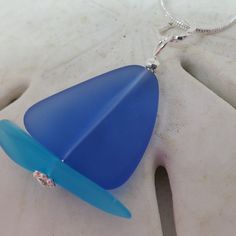 "SAILBOAT Sea Glass Jewelry - Necklace, Pendant. Unique \"Sailboat\" design for sailors, boaters and coastal, beach, ocean lovers. Nautical cultured sea glass, beach glass. SAPPHIRE BLUE \"Sails\" / TURQUOISE BLUE \"Hull\" freeform cultured sea glass. Non-tarnishing, silver plated accents and wire. Pendant length approximately 1.5 inches. Silver plated 18\" chain included. Nickel Free. Handmade in the USA. \"Cultured\" Sea Glass Jewelry - Eco-friendly sea glass, beach glass made from recycled gl Sailboat Necklace, Glass Necklace Pendant, Jewelry Sapphire, Beach Glass Necklace, Sailboat Design, Glass Beach, Sea Glass Beach, Special Occasion Jewelry, Wire Pendant