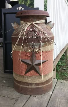 an old barrel is decorated with stars and burlocks for the decoration on this day