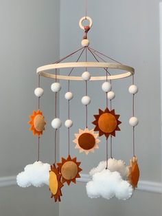 a mobile with sun and clouds hanging from it