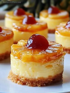 mini cheesecakes with jelly and pineapple topping on a white plate, ready to be eaten