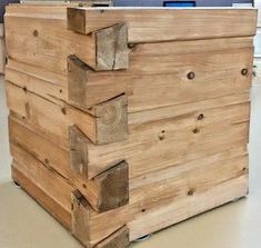 a stack of wooden crates sitting on top of a floor next to a computer desk