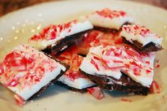 pieces of cake with white and red toppings are on a plate, ready to be eaten