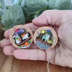 two small toy cars are in a wooden container